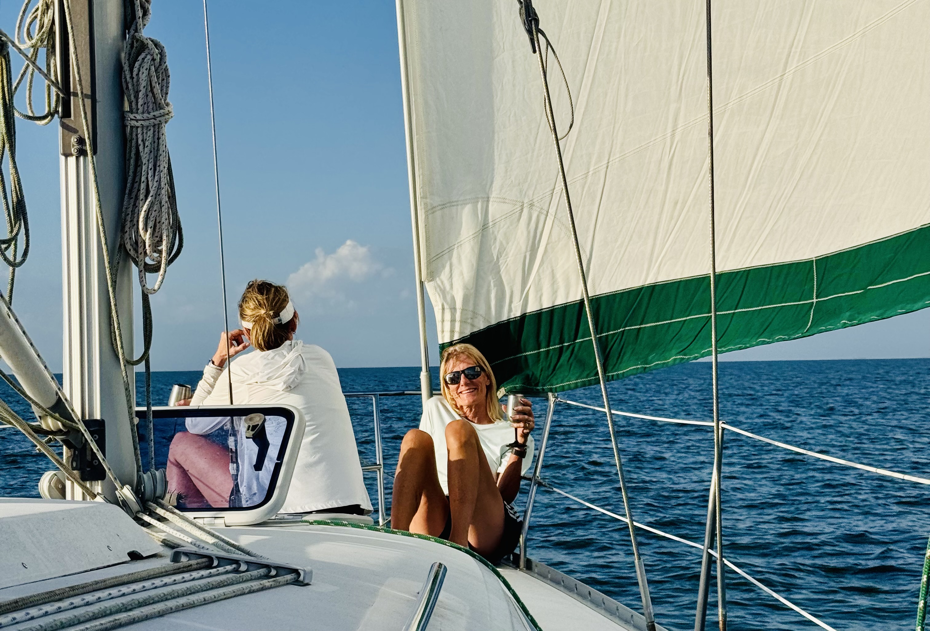 Guests relaxing on the foredeck while sailing
